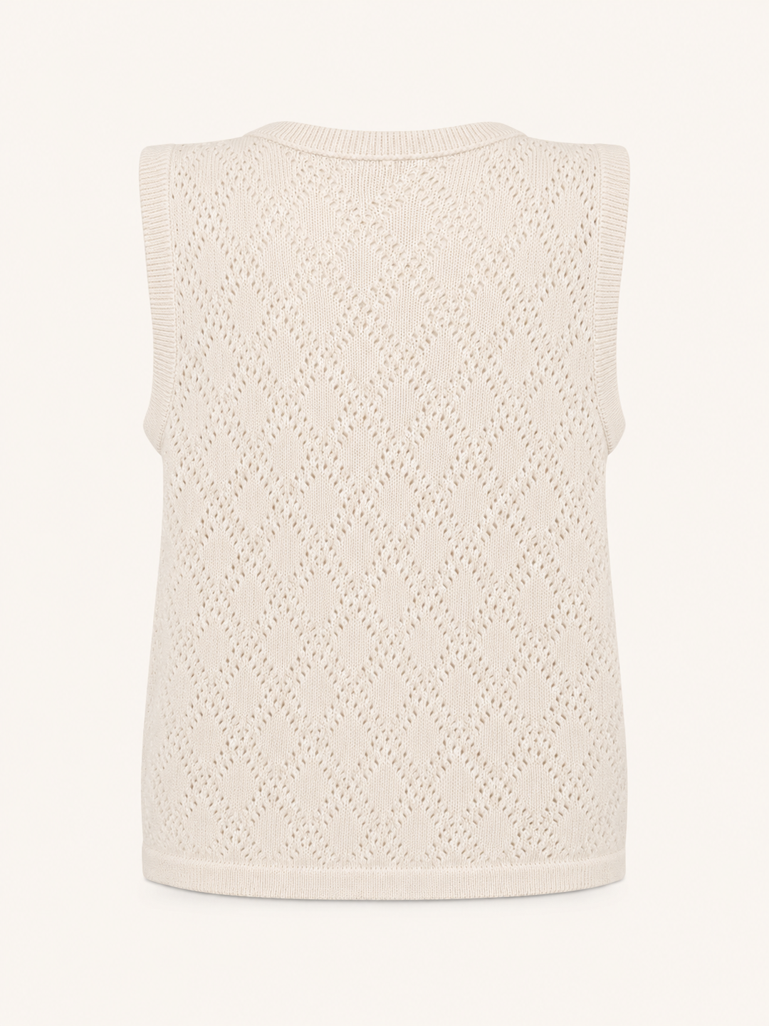 A sleeveless knit vest in a warm cream or off-white color, featuring an openwork diamond lattice pattern and ribbed trim, shown against a plain light background.